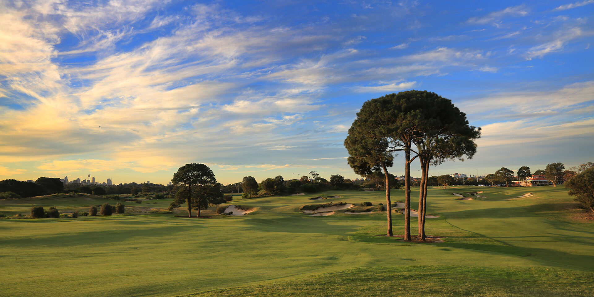 Tree-lined fairway and bunkers at Bonnie Doon Golf Club at sunset